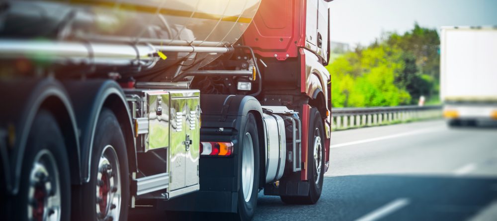 Trucking Industry - red 18-wheeler on highway